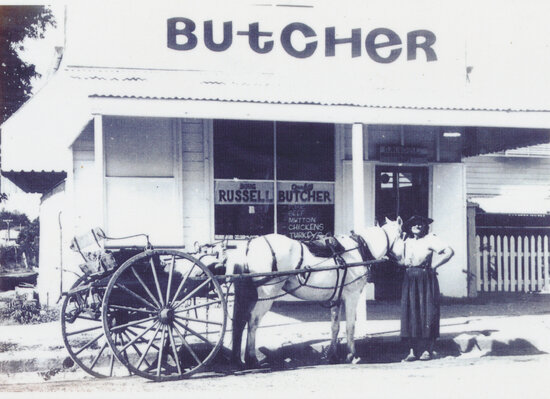 Mrs Patterson outside Doug Russell&rsquo;s Butcher Shop, Queenton, 1972
