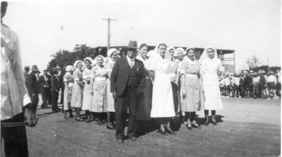 Jupiter Mosman with a group of nurses outside the hospital in Gill Street prior to the TPA New Years Day Sports procession, January 1941