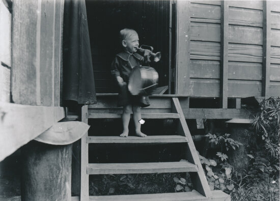 Horace Meredith Wooster on back stairs playing musical instruments
