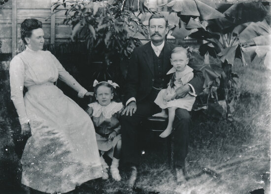 Horace &amp; Harriet Wooster with their children Edna (Norma?) and Horace in Backyard