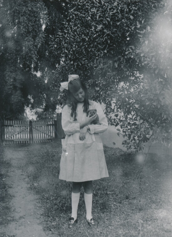 Unknown girl holding a puppy