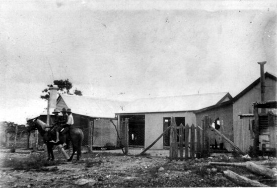 Three boys on horseback in front of Unknown House in the bush