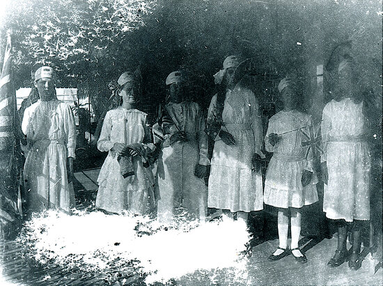 Comfort Fund girls holding flags and possibly knitted socks