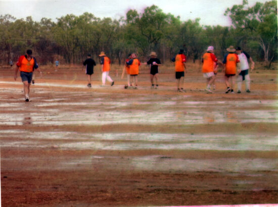 Players standing in waterlogged field during 2003 Goldfield Ashes