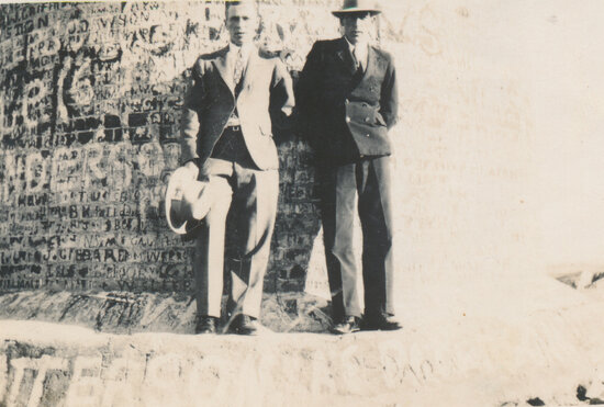 Two men standing at base of the Pyrites Works Chimney, Towers Hill