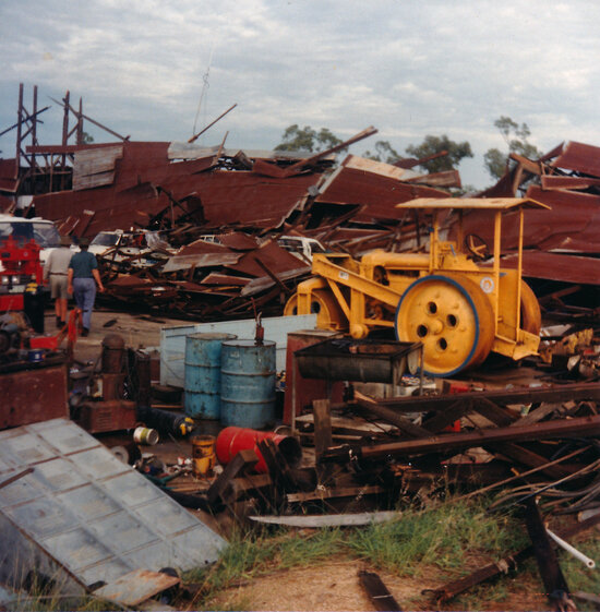 Old road roller in amongst wreckage of collapsed igloo used by City Council as a works depot following a storm