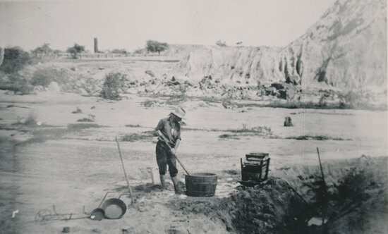 Man working at washing for gold, near a Tailings Heap