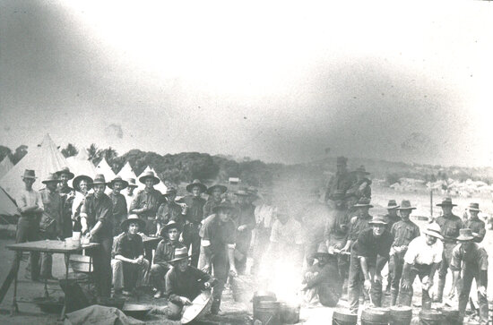 Group of Military personnel at Kissing Point, posing around cooking fire