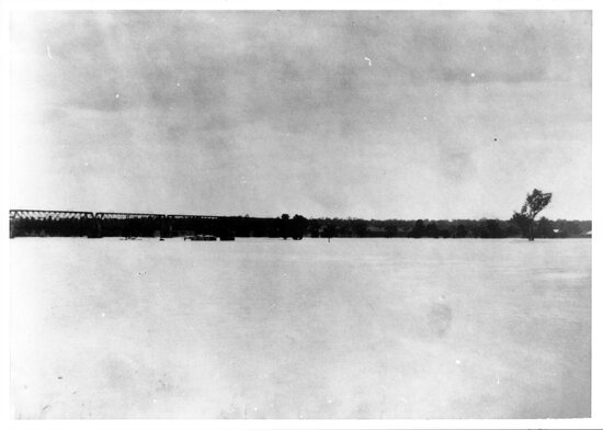 Burdekin River in flood with rail-bridge in background