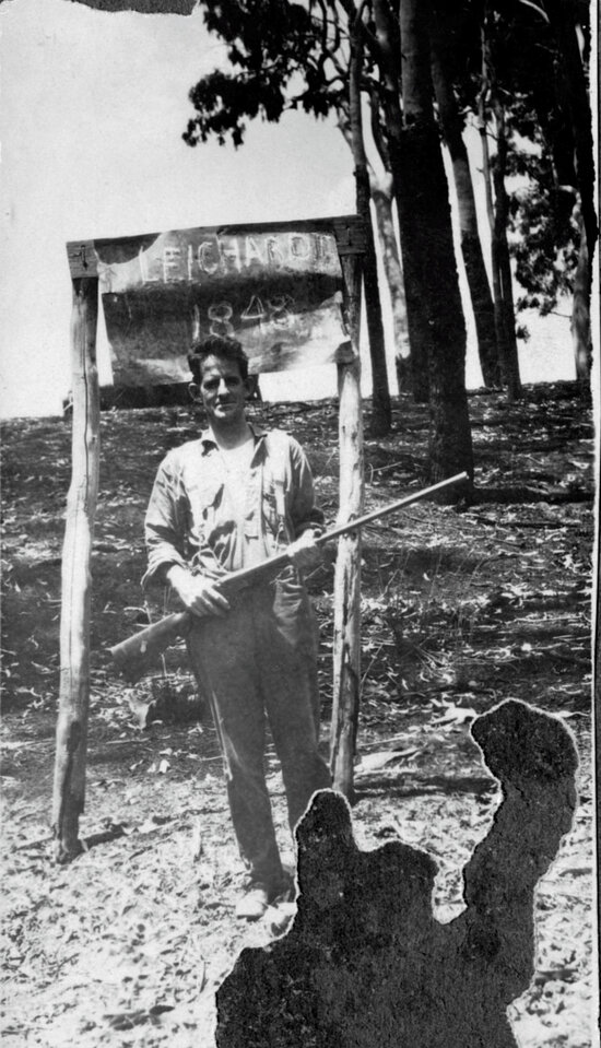 Man with rifle beside Leichhardt Marker