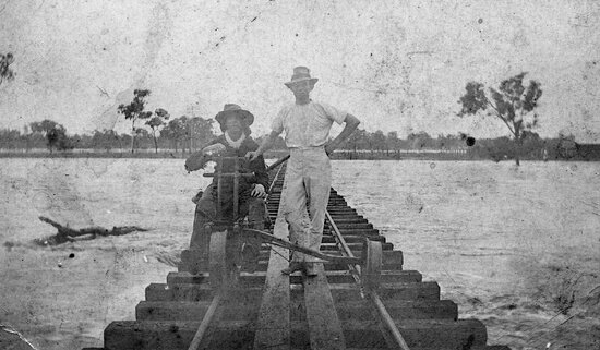 Ganger Halpin and Mr Hickey on Rail bridge over Homestead Creek in Flood, 1931