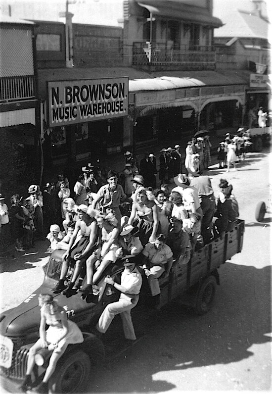 Soldiers wearing dresses on float in World War Two Parade