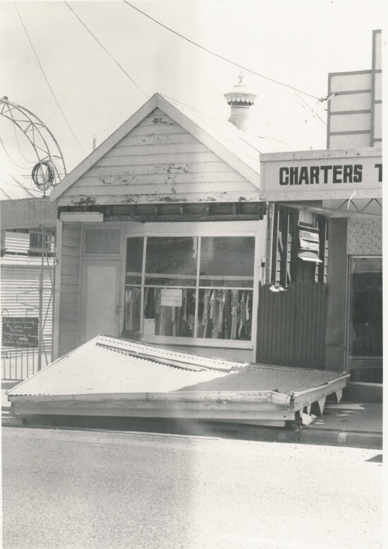 Small shop with collapsed front awning in front of MU Hall, Gill Street