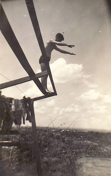 Man preparing to dive from wooden stand, Replenishment Centre, Towers Hill 1940s
