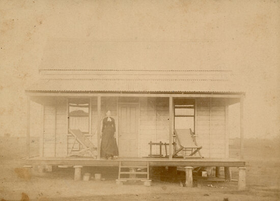 Woman on the verandah of a miner&rsquo;s cottage