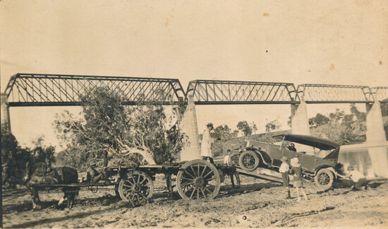 Unloading a car from a wagon after being towed across Burdekin River at Macrossan Rail Bridge