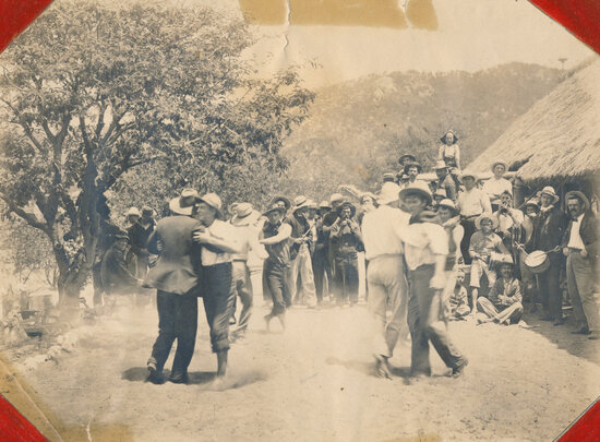 Men dancing together in bush setting