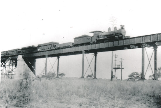 Macrossan railway bridge with steam train crossing