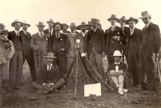 Men with rifles and prize cup