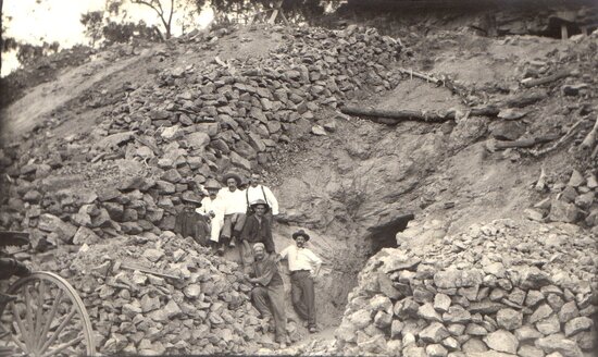 Miners at the entrance to a mineshaft or underlie