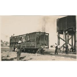Railway workers attempting to put out fire in timber railway wagon at Railway Siding - Possibly Mingela