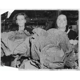 Mrs Johnston and Mrs Hadrell holding cabbages grown for the Brisbane Show 1936