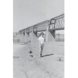 Woman on the riverbed below Macrossan Rail Bridge, Burdekin River, 1959
