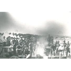 Group of Military personnel at Kissing Point, posing around cooking fire