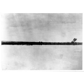 Burdekin River in flood with rail-bridge in background
