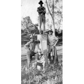 Four men beside Leichhardt Memorial