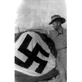 John Anning in El-Alamein, Egypt with captured Swastika flag