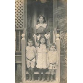 Woman with three children on steps