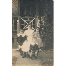 Woman with three children on front steps