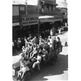 Soldiers wearing dresses on float in World War Two Parade