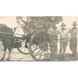 Three Bushmen Standing Beside a Heavily Laden Horse Drawn Cart