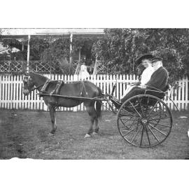Margaret Paull and her father Christie Paull sitting in a sulky