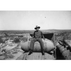RAAF Replenishment Centre With Man Sitting on Rack of Bombs, Towers Hill
