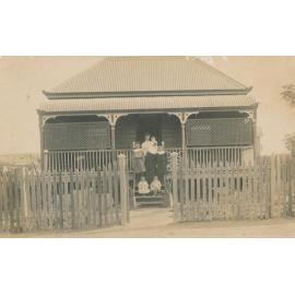 Mother With Children on Stairs of cottage
