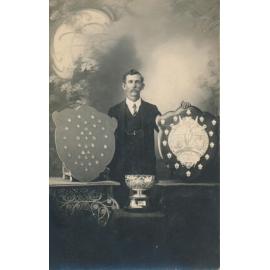 Man With Trophy and Shields