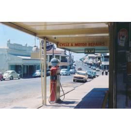 Petrol bowser outside Charters Towers Cycle and Motor Works, Gill Street, 1965