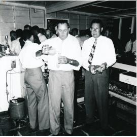 Men including Don Ryan behind the bar at the Golf Club, 1950s