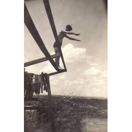 Man preparing to dive from wooden stand, Replenishment Centre, Towers Hill 1940s
