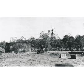 Men working on water pipe on a bush station