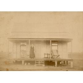 Woman on the verandah of a miner’s cottage