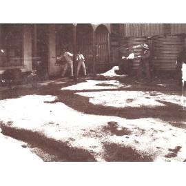 Men having a snowball fight with hail stones