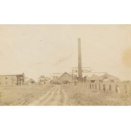 Large chimney with buildings
