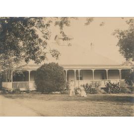 Maids/nurses with children outside house