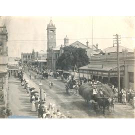 Parade in Gill st with hay wagon signed ‘Harvesters’