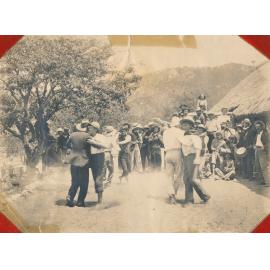 Men dancing together in bush setting