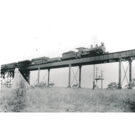 Macrossan railway bridge with steam train crossing